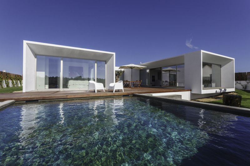 Modern contemporary house with garden swimming pool and wooden deck Modern Architectural House Design showing a Modern contemporary house with garden swimming