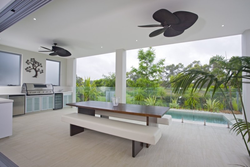 Under cover outdoor barbecue kitchen area overlooking swimming pool Under cover outdoor barbecue kitchen area overlooking swimming pool